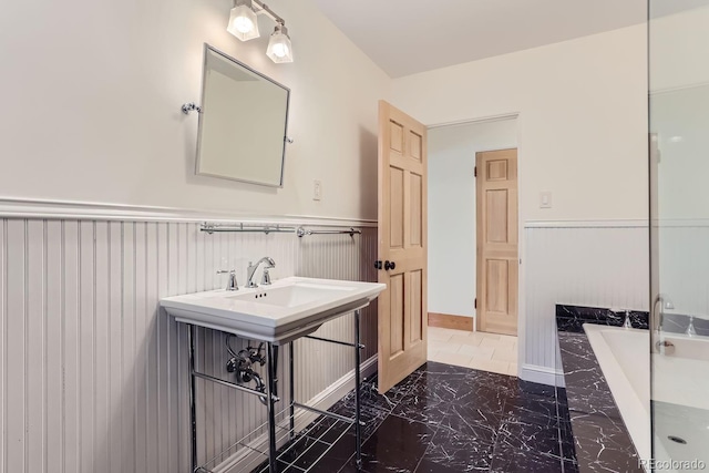 bathroom with a relaxing tiled tub