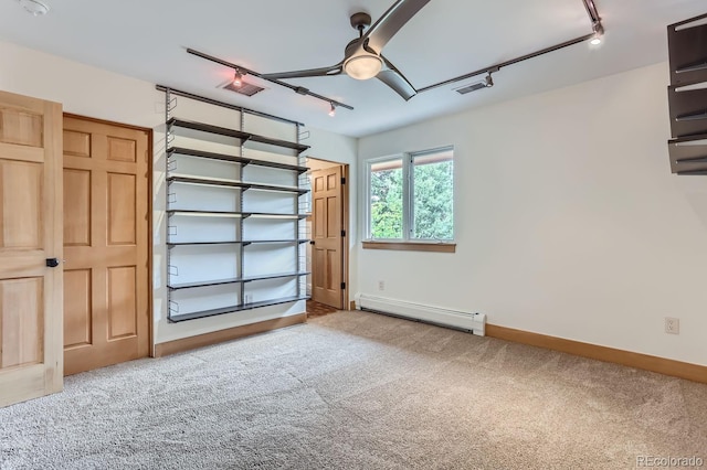 garage with ceiling fan and baseboard heating