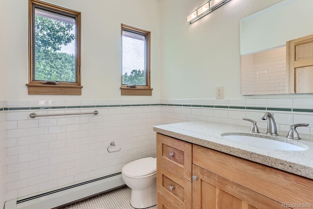 bathroom featuring toilet, a baseboard radiator, tile walls, tile patterned floors, and vanity