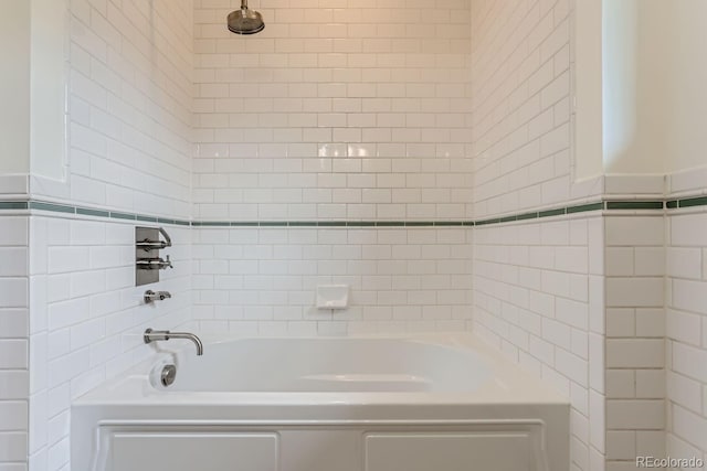 bathroom featuring tile walls and a bathing tub