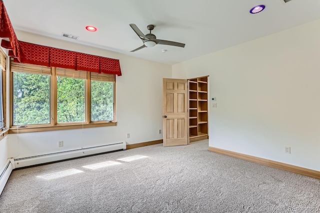 empty room featuring ceiling fan, carpet floors, and a baseboard radiator