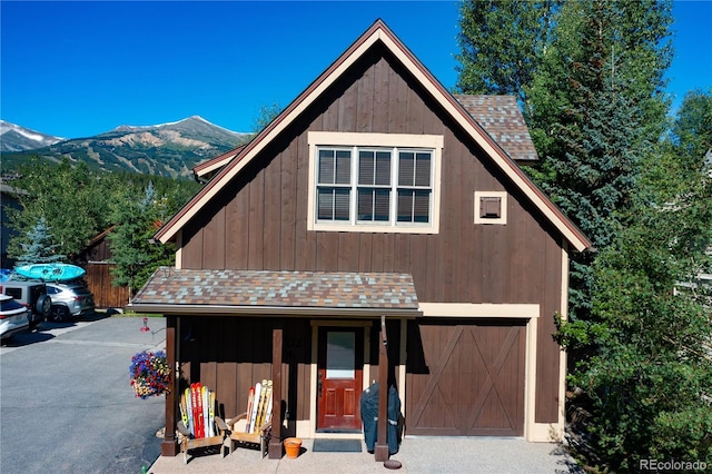 302 N Main St, Breckenridge, CO 80424 - view of front of house with roof with shingles, a mountain view, and a garage