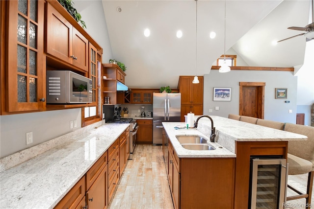 302 N Main St, Breckenridge, CO 80424 - kitchen featuring beverage cooler, appliances with stainless steel finishes, vaulted ceiling, brown cabinetry, and a sink