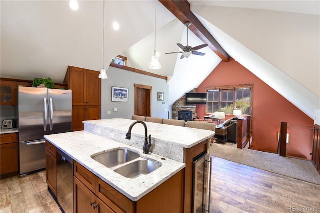 302 N Main St, Breckenridge, CO 80424 - kitchen featuring freestanding refrigerator, a sink, brown cabinetry, light wood-type flooring, and a ceiling fan