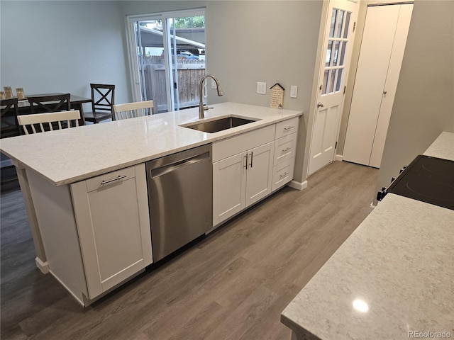 kitchen with stainless steel dishwasher, dark wood-style flooring, a peninsula, light countertops, and electric range oven