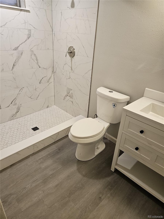 bathroom featuring vanity, wood finished floors, and a shower stall