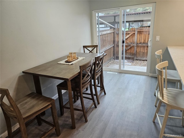 dining room featuring wood finished floors and baseboards