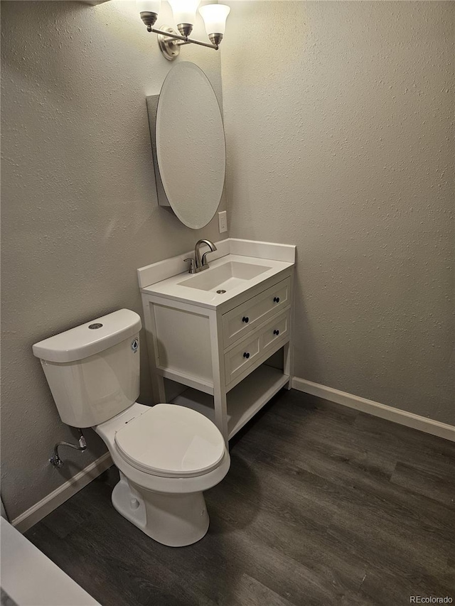 half bath featuring wood finished floors and vanity