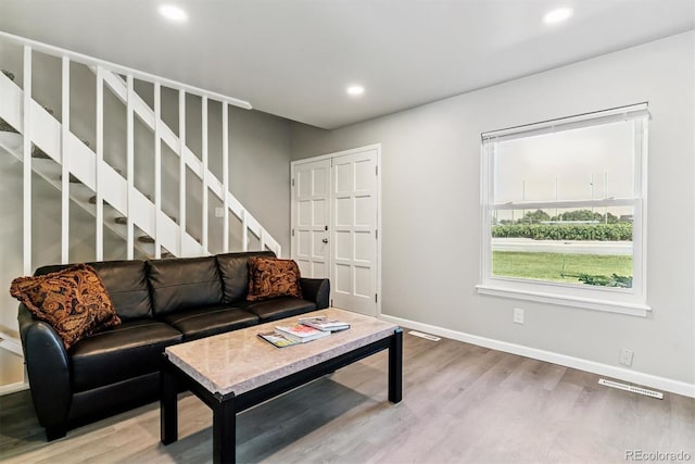 1927 S Peoria St, Aurora, CO 80014 - living area with light wood finished floors, stairs, and recessed lighting
