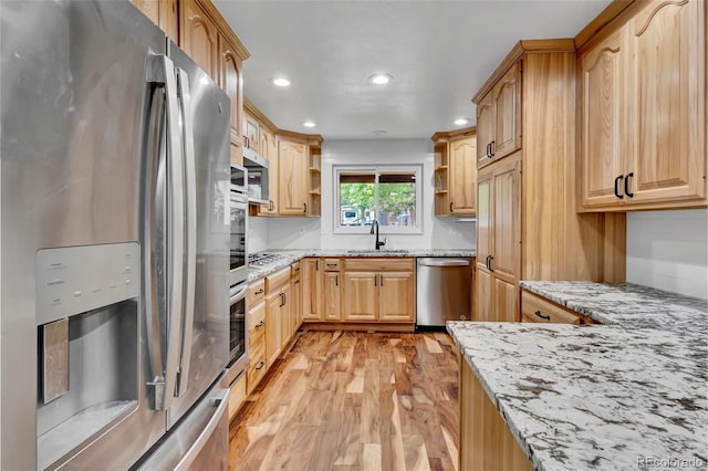 13624 Omega Cir, Lone Tree, CO 80124 - kitchen featuring appliances with stainless steel finishes, open shelves, light wood-style floors, light stone countertops, and recessed lighting