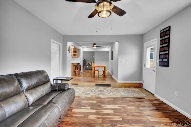 13624 Omega Cir, Lone Tree, CO 80124 - living room featuring ceiling fan, wood finished floors, and baseboards