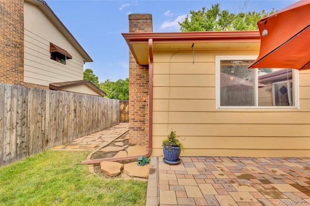 13624 Omega Cir, Lone Tree, CO 80124 - view of home's exterior with a chimney and a patio