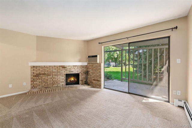 unfurnished living room with carpet flooring, a fireplace, a wall mounted AC, and a baseboard radiator