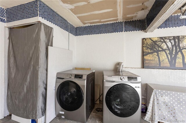 washroom with washer and dryer