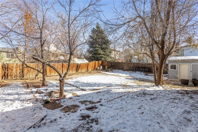 view of yard layered in snow