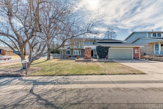 view of front of home with brick siding, driveway, an attached garage, and a front yard