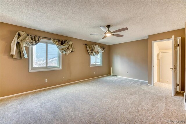 unfurnished bedroom featuring ceiling fan, baseboards, and carpet