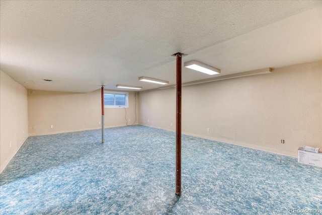 below grade area featuring a textured ceiling and carpet