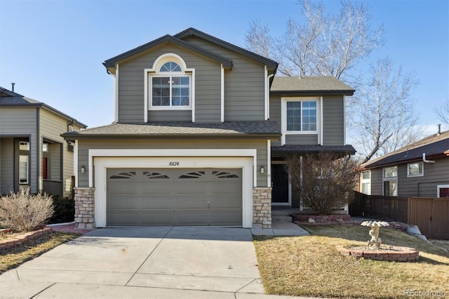 view of front facade featuring a garage, concrete driveway, stone siding, and fence