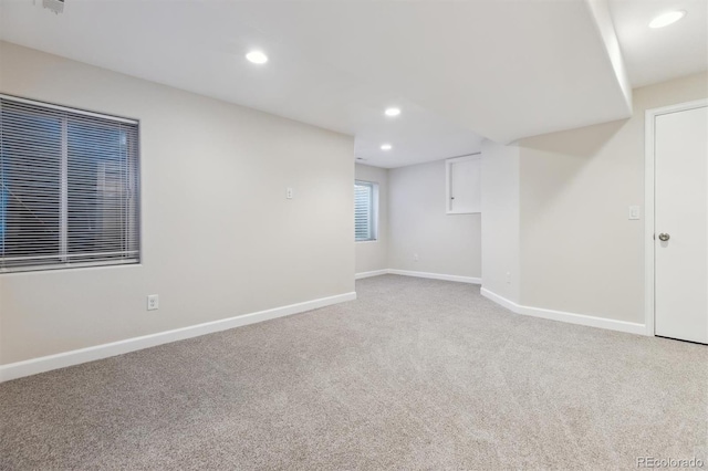 carpeted spare room featuring recessed lighting and baseboards