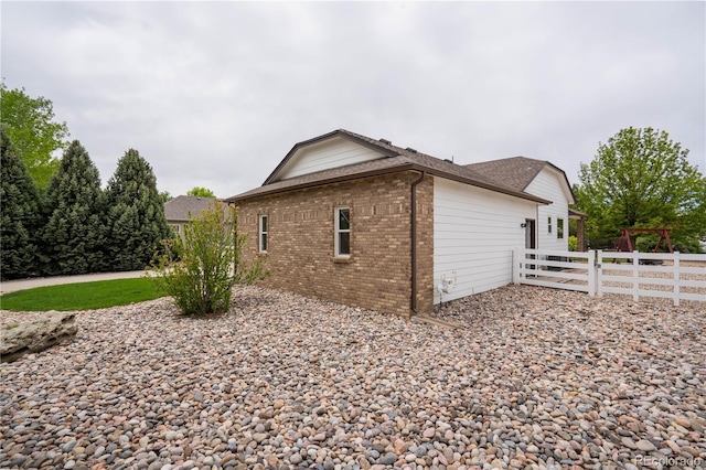 view of side of property with brick siding