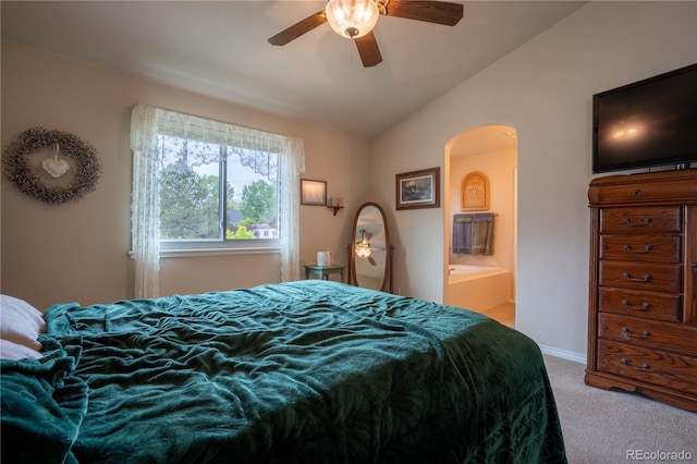 bedroom with carpet floors, arched walkways, lofted ceiling, ensuite bathroom, and a ceiling fan