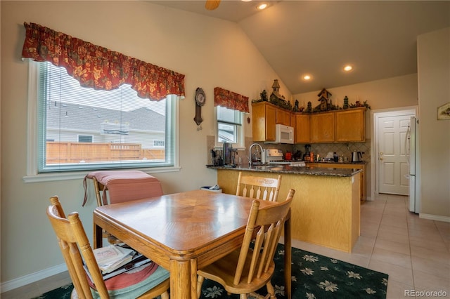 dining space with vaulted ceiling, light tile patterned floors, recessed lighting, and baseboards