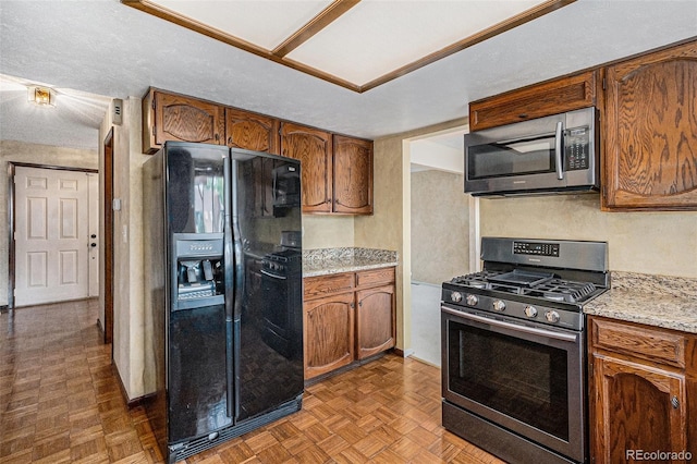 7655 S Ogden Way, Centennial, CO 80122 - kitchen with stainless steel appliances, brown cabinetry, and light stone countertops