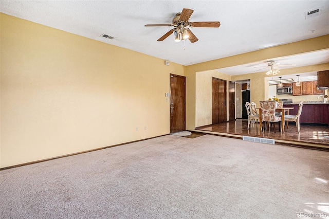 7655 S Ogden Way, Centennial, CO 80122 - living area with ceiling fan, carpet floors, and baseboards