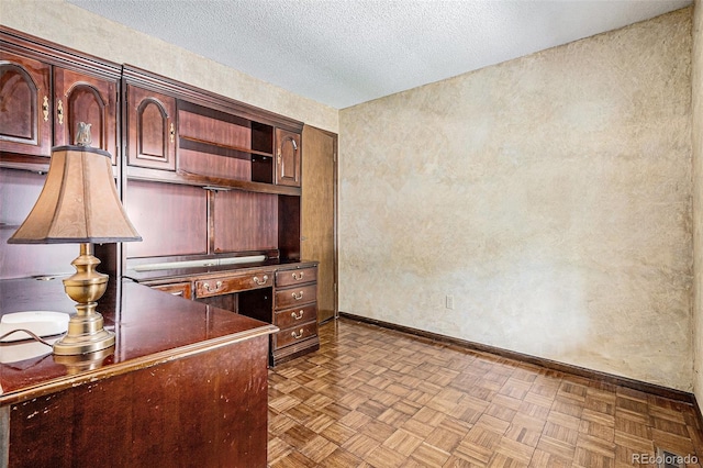 7655 S Ogden Way, Centennial, CO 80122 - unfurnished office featuring a textured ceiling and baseboards