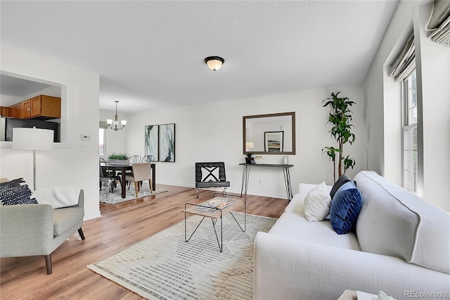 9946 Harrison St, Thornton, CO 80229 - living area with a chandelier, plenty of natural light, light wood finished floors, and baseboards