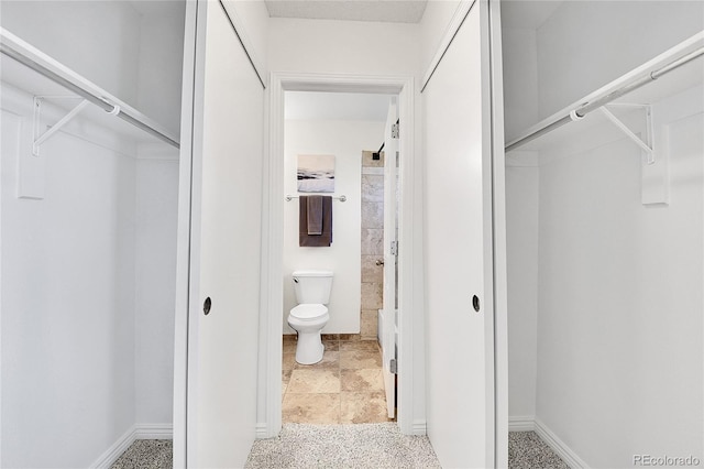 9946 Harrison St, Thornton, CO 80229 - bathroom with a walk in closet, toilet, and baseboards