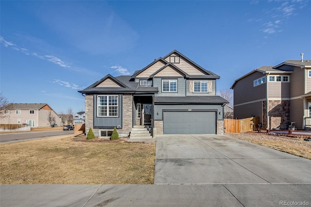 view of front of home featuring stone siding, an attached garage, concrete driveway, and fence