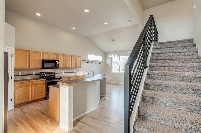 kitchen featuring stainless steel range with electric stovetop, light wood-style flooring, light brown cabinets, black microwave, and decorative backsplash