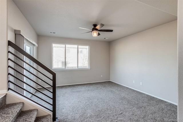 stairs featuring carpet flooring, visible vents, baseboards, and ceiling fan