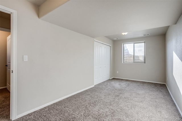 unfurnished bedroom featuring carpet flooring, baseboards, and visible vents