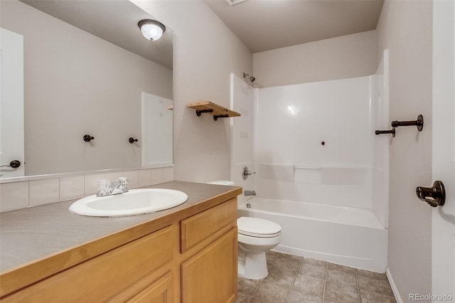 bathroom featuring tile patterned flooring, toilet, vanity, and  shower combination