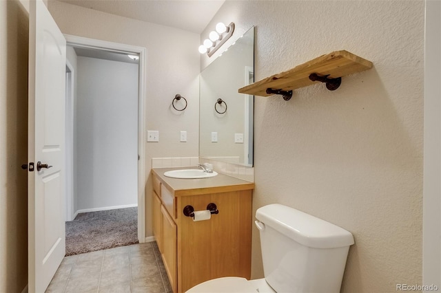 bathroom featuring tile patterned floors, toilet, and vanity