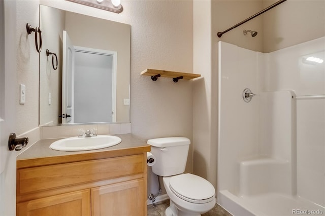 bathroom featuring vanity, toilet, and walk in shower