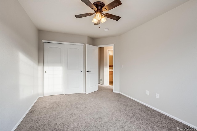 unfurnished bedroom featuring a closet, ceiling fan, baseboards, and carpet floors