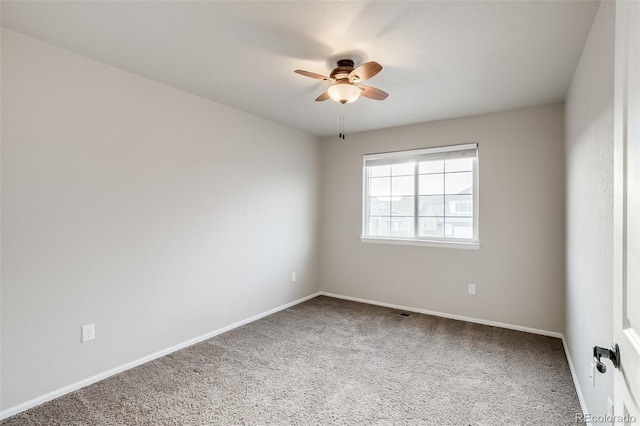 spare room featuring baseboards, a ceiling fan, and carpet floors