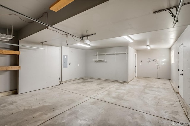 garage with electric panel and a garage door opener