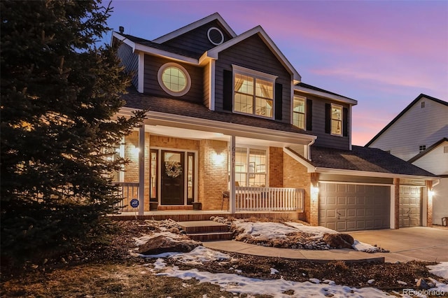 view of front of home featuring a garage and a porch