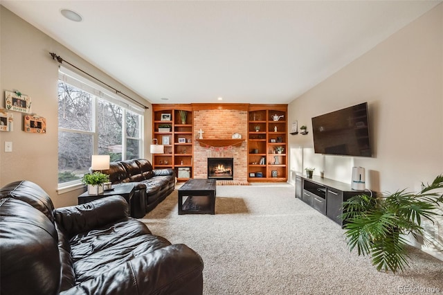 carpeted living room featuring built in shelves and a brick fireplace