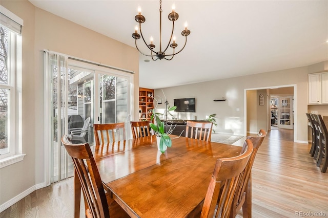 dining room featuring an inviting chandelier and light hardwood / wood-style flooring