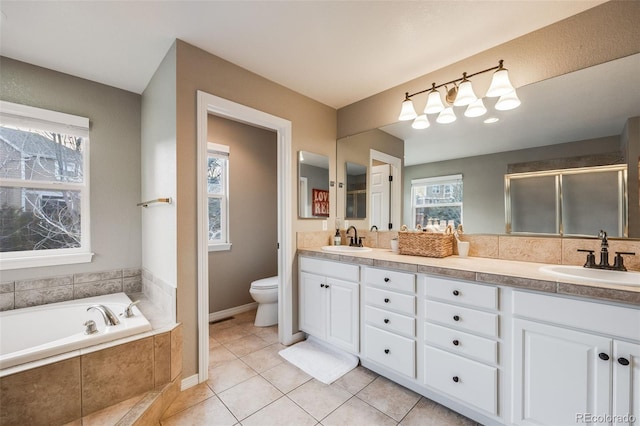 full bathroom featuring vanity, toilet, tile patterned flooring, and shower with separate bathtub