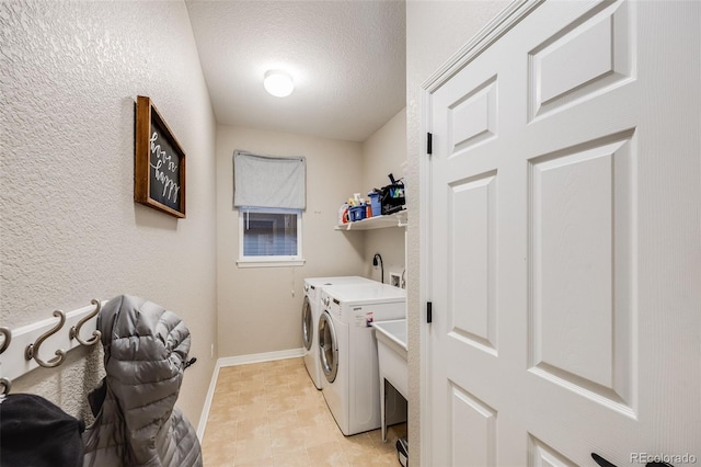 laundry room with washer and clothes dryer and a textured ceiling