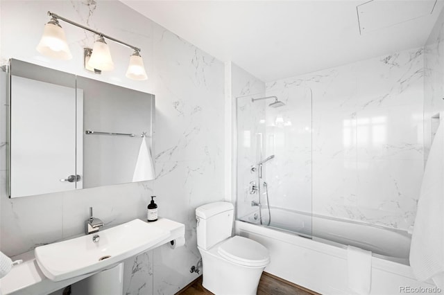 full bathroom featuring toilet, sink, tile walls, and tiled shower / bath