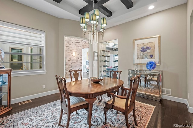 dining area with visible vents, dark wood finished floors, baseboards, and an inviting chandelier