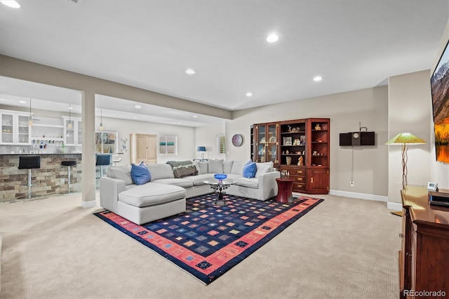 living room featuring light carpet, baseboards, and recessed lighting